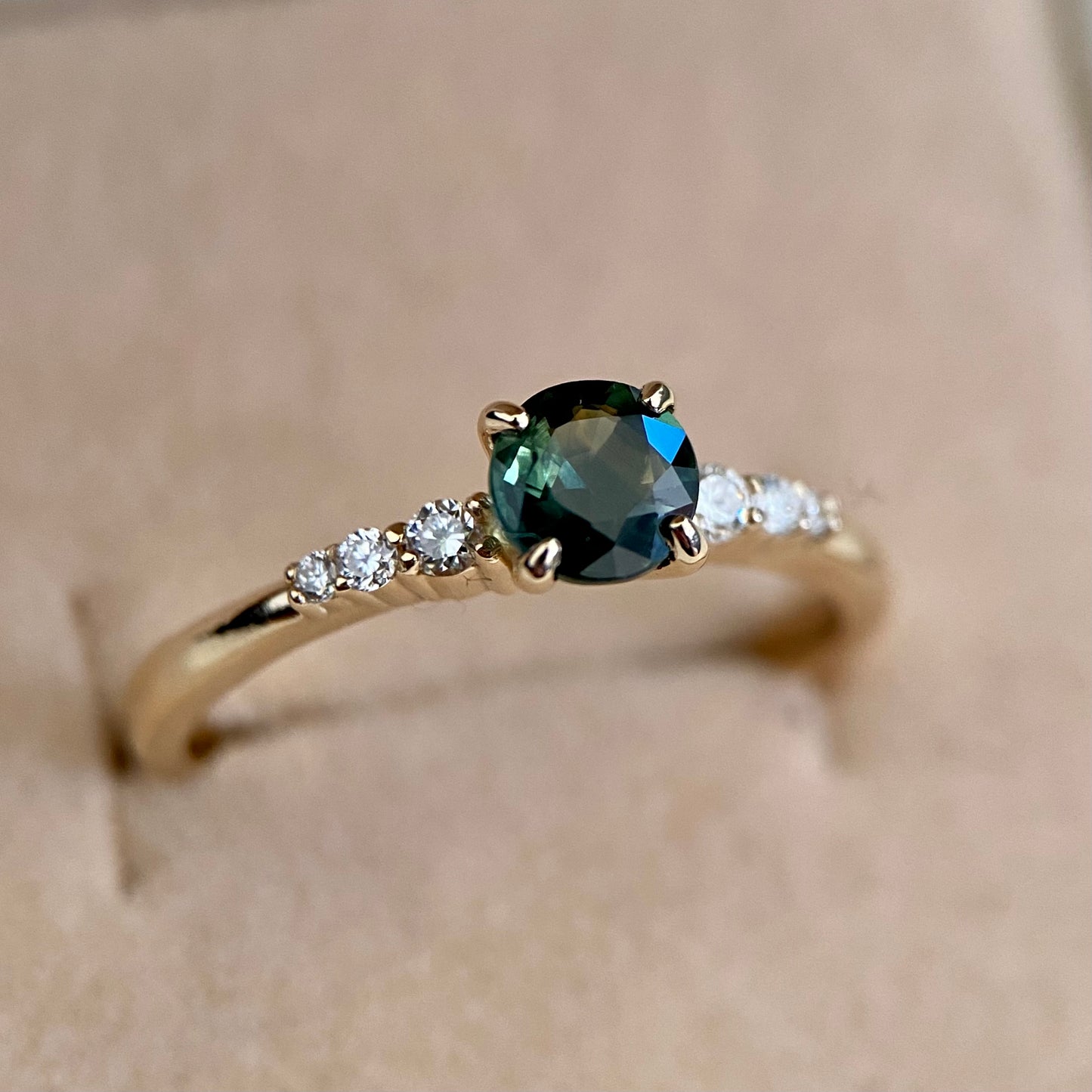 Teal round cut sapphire engagement ring