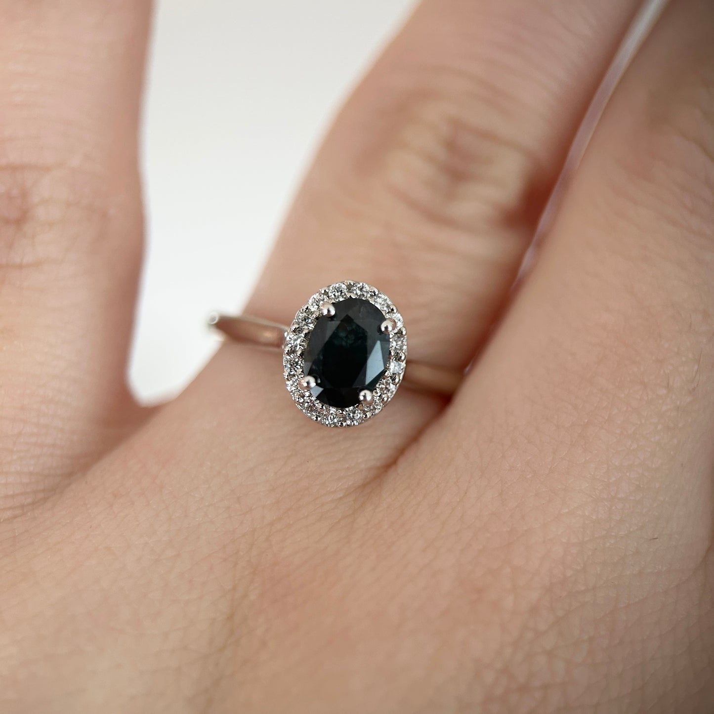 Black oval sapphire halo engagement ring