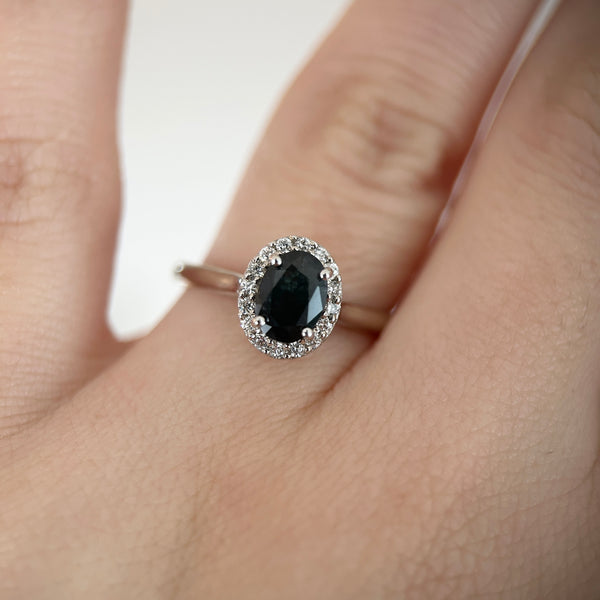 Black oval sapphire halo engagement ring in 14K gold