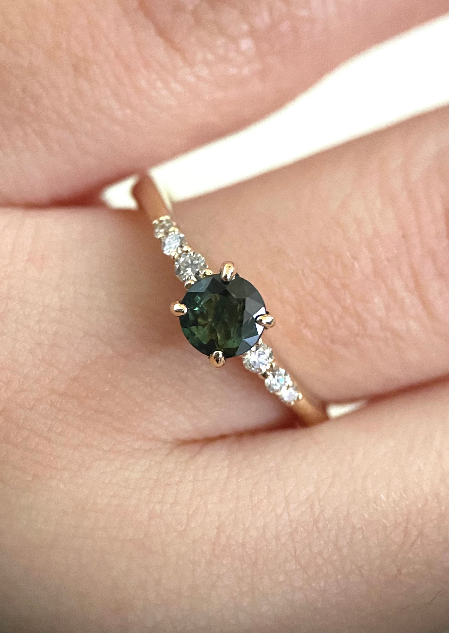 Teal round cut sapphire engagement ring