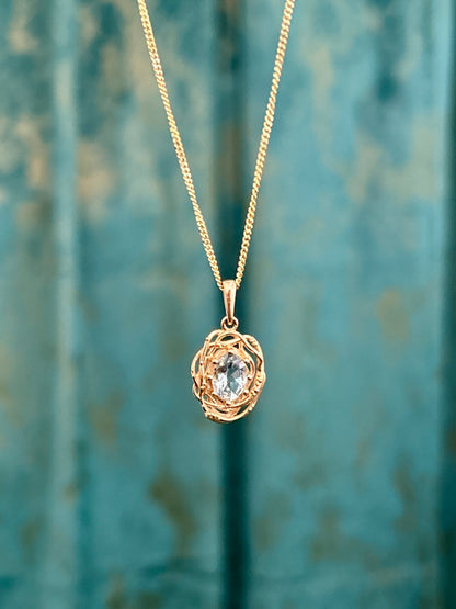 Oval natural aquamarine Nest pendant in 14K yellow gold