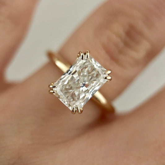 Double prong radiant cut diamond solitaire ring.