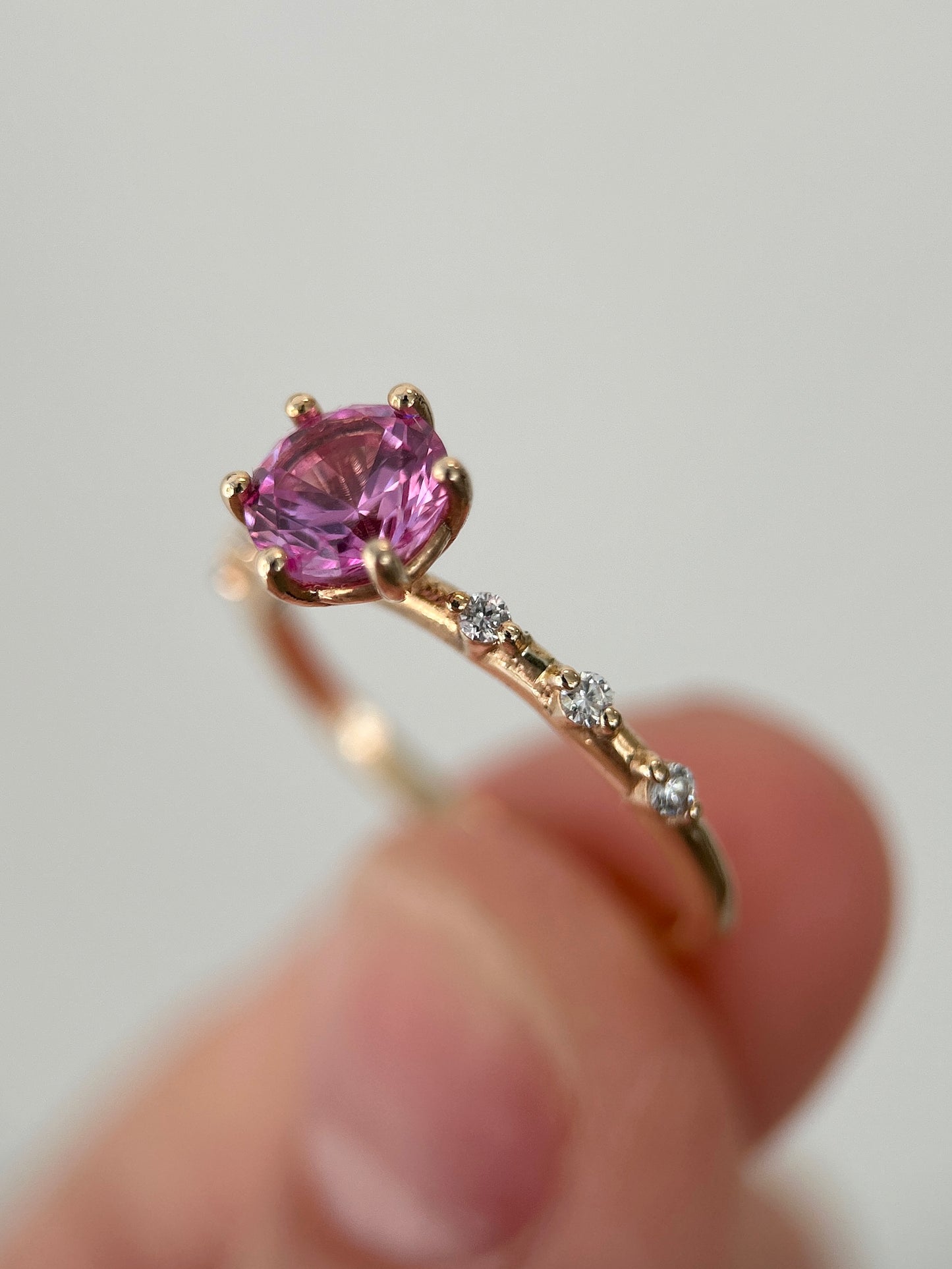 Six prongs round cut lab grown pink sapphire ring in 14K yellow gold