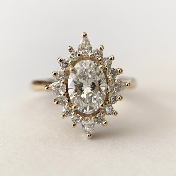 Vintage inspired sunburst halo oval diamond engagement ring in 14K