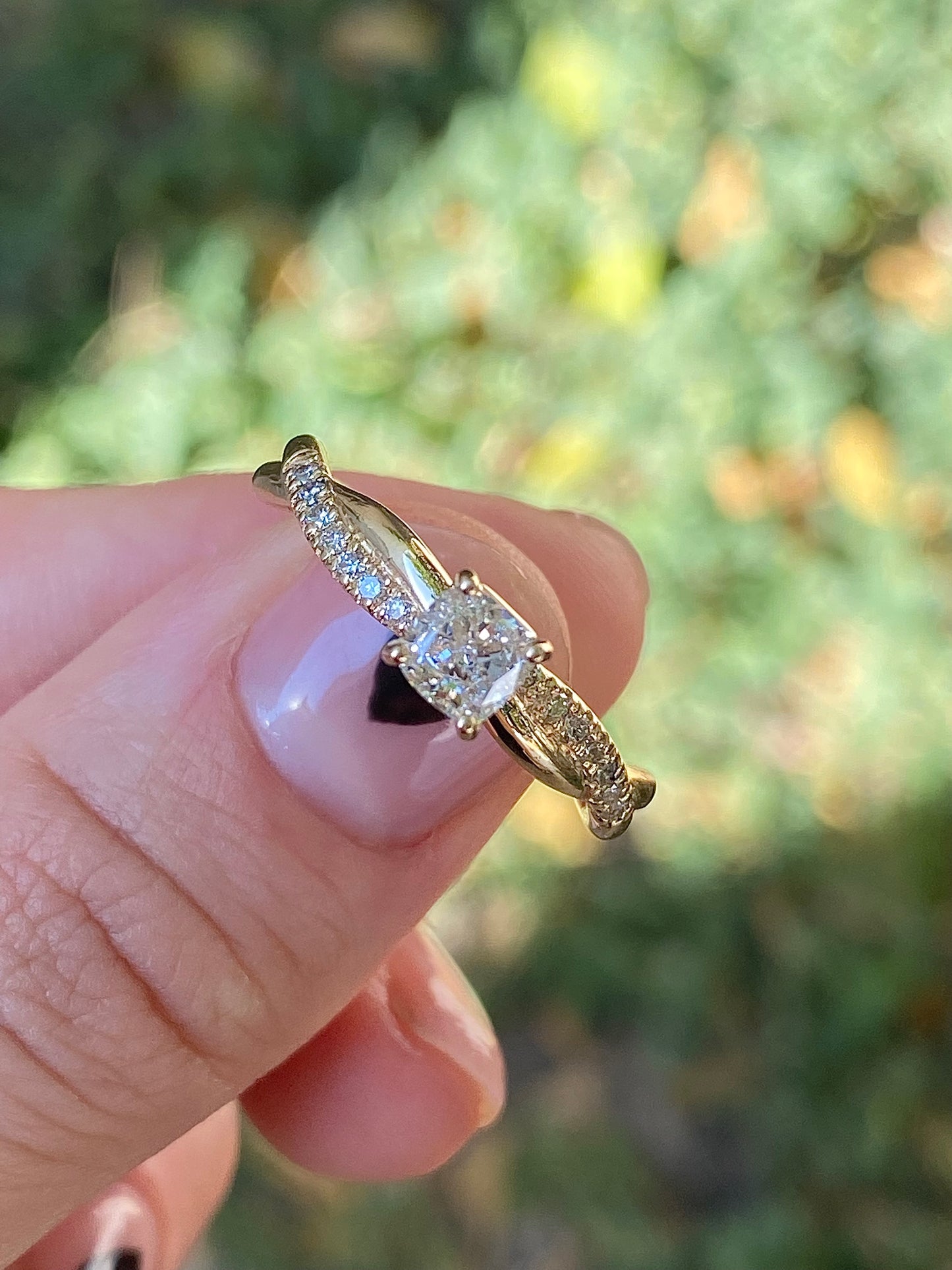 Twisted cushion cut diamond engagement ring