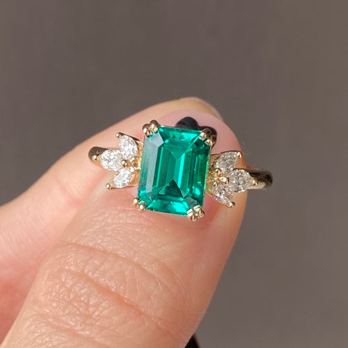 Winged emerald cut engagement ring