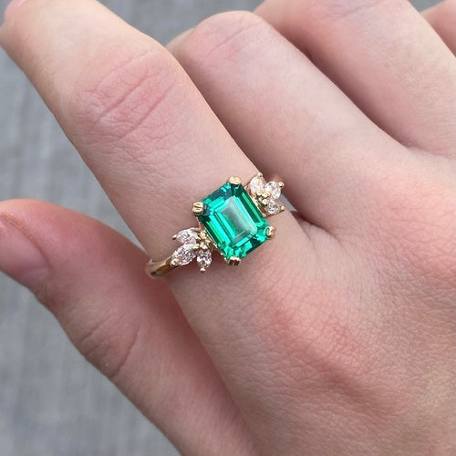 Winged emerald cut engagement ring