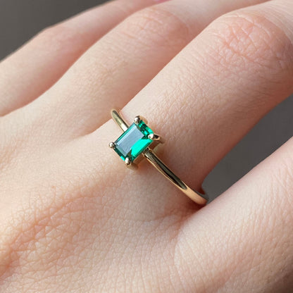 Petite emerald solitaire ring