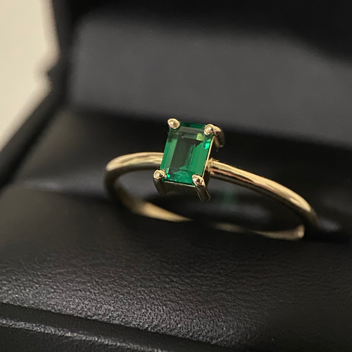 Petite emerald solitaire ring