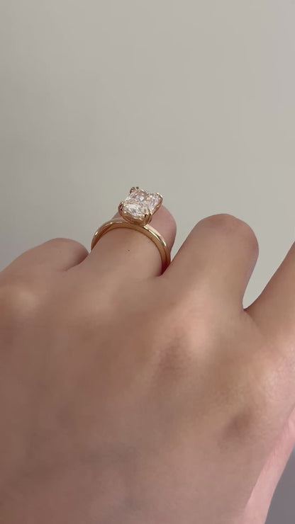 14K Double prong radiant cut diamond solitaire ring.