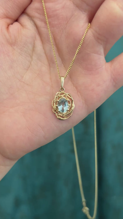 Oval natural aquamarine Nest pendant in 14K yellow gold