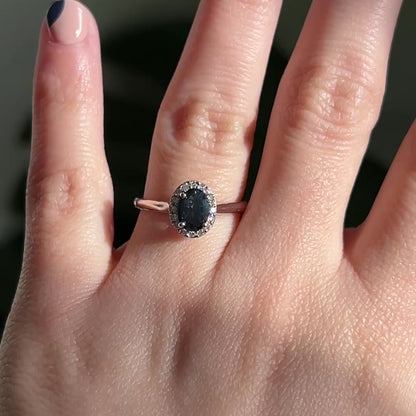 Black oval sapphire halo engagement ring